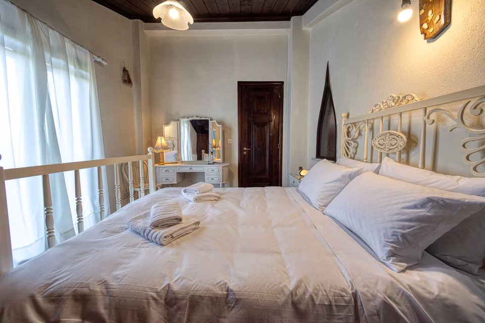 Loft bedroom with white iron bed