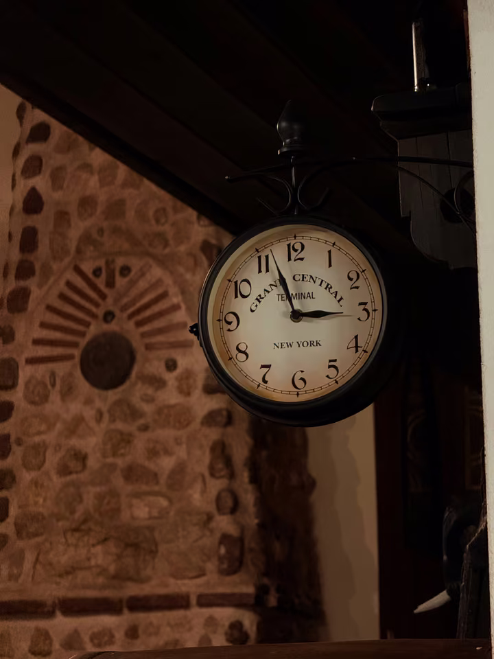 Station clock on the stone wall