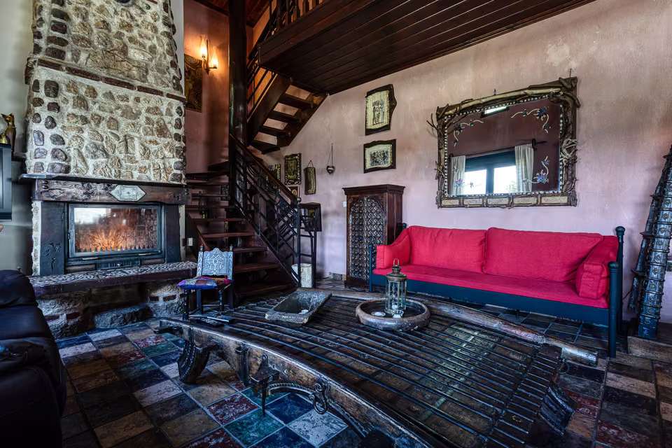 Red sofa beside the fireplace