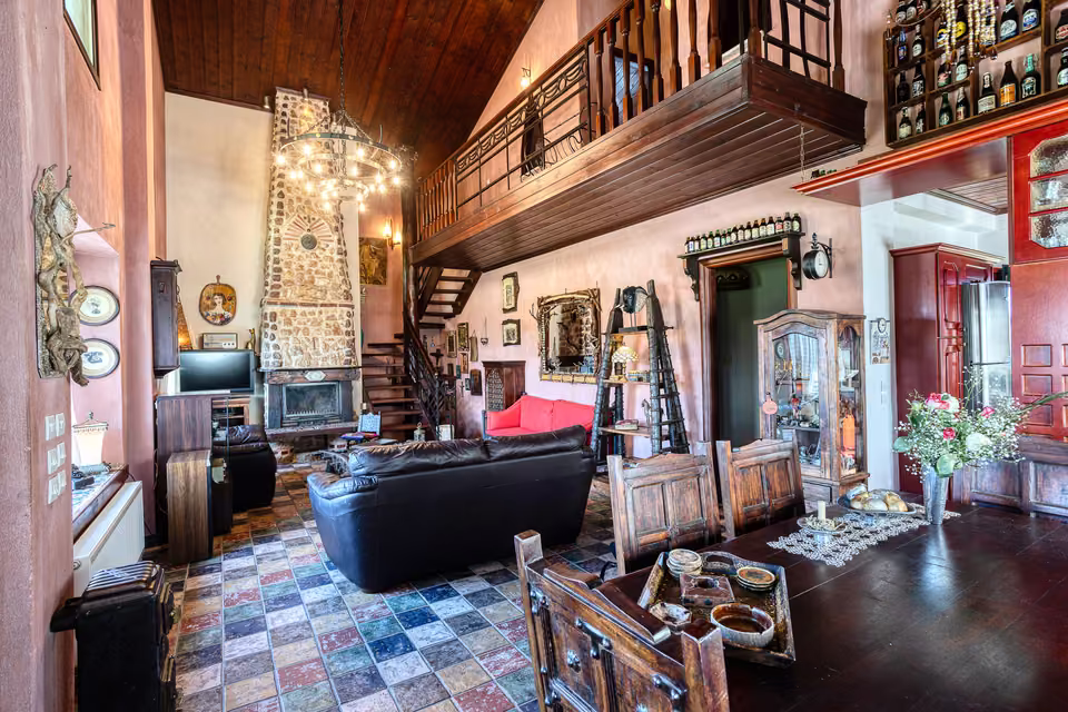 Living room with chandelier and loft